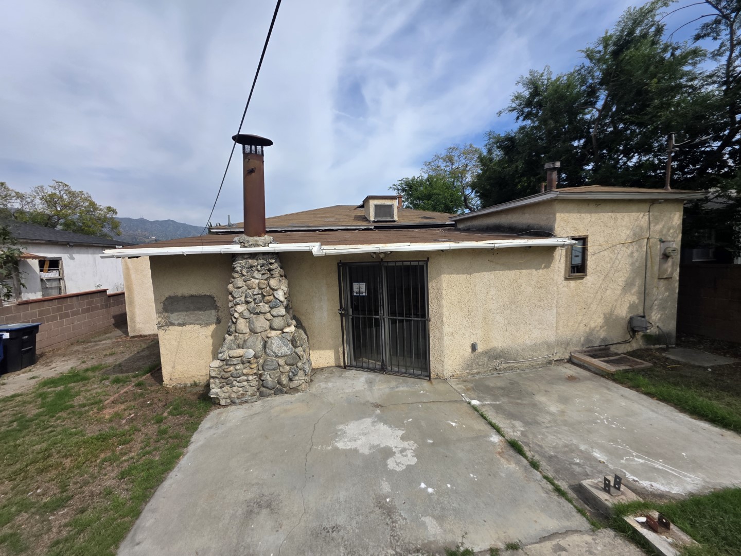 Rear exterior with stone chimney