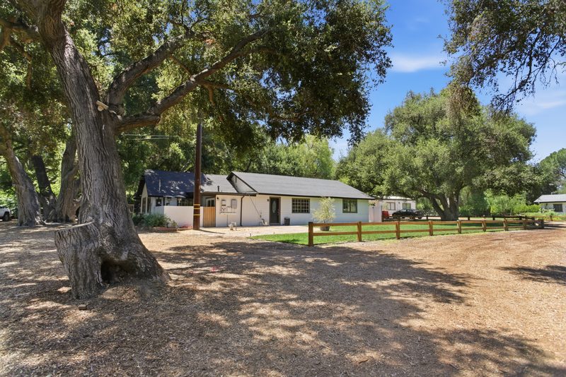 The main home beneath the oaks
