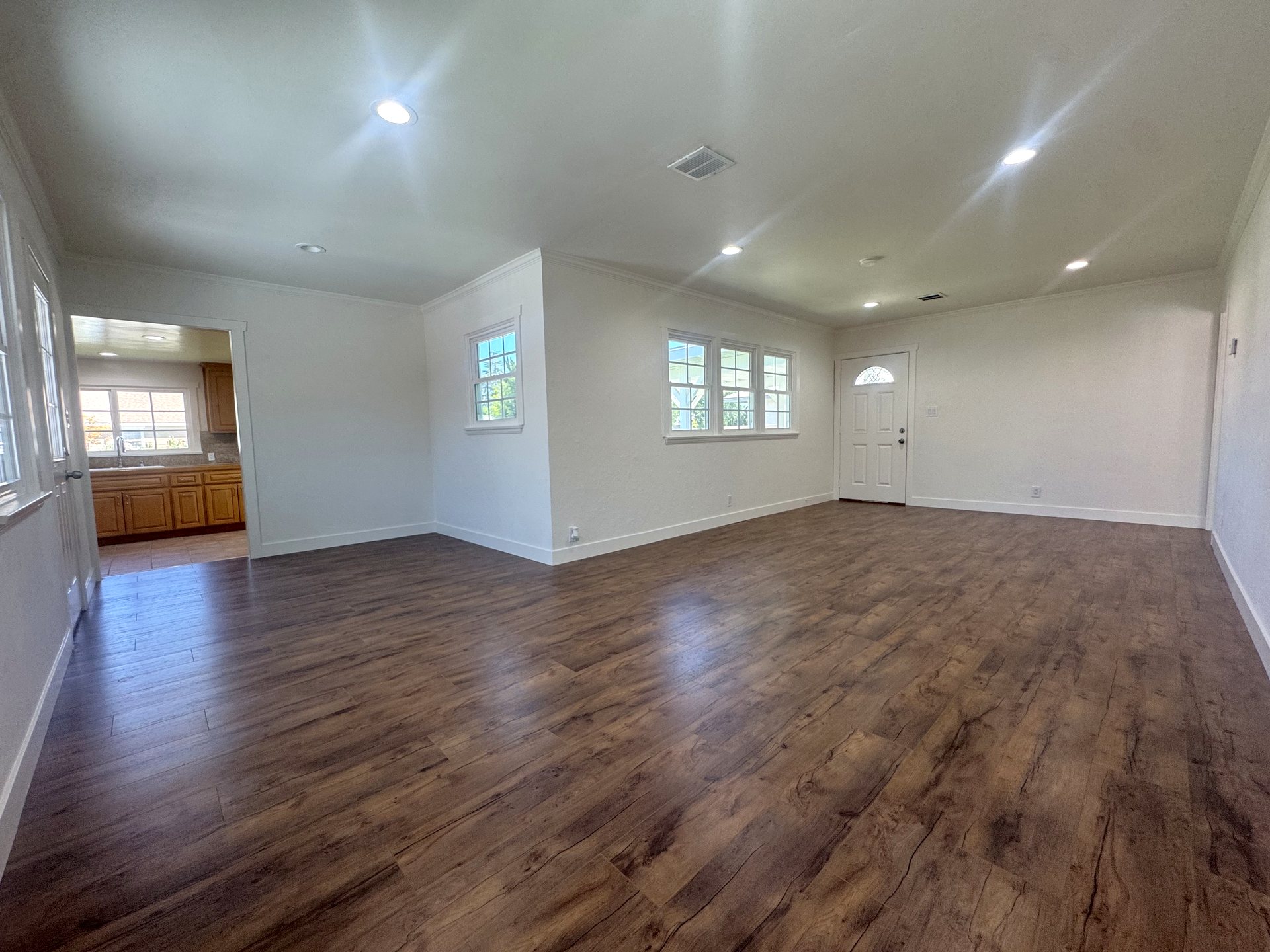 Bright open living area with new wood flooring